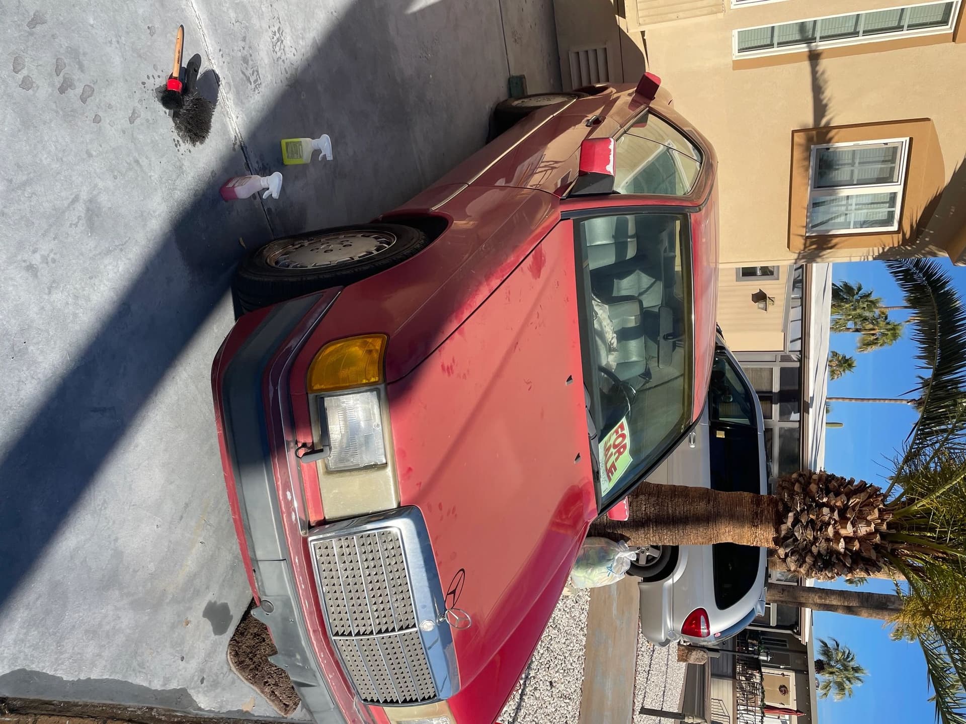 A red coupe being detailed on a driveway by Gabe's Mobile Detailing